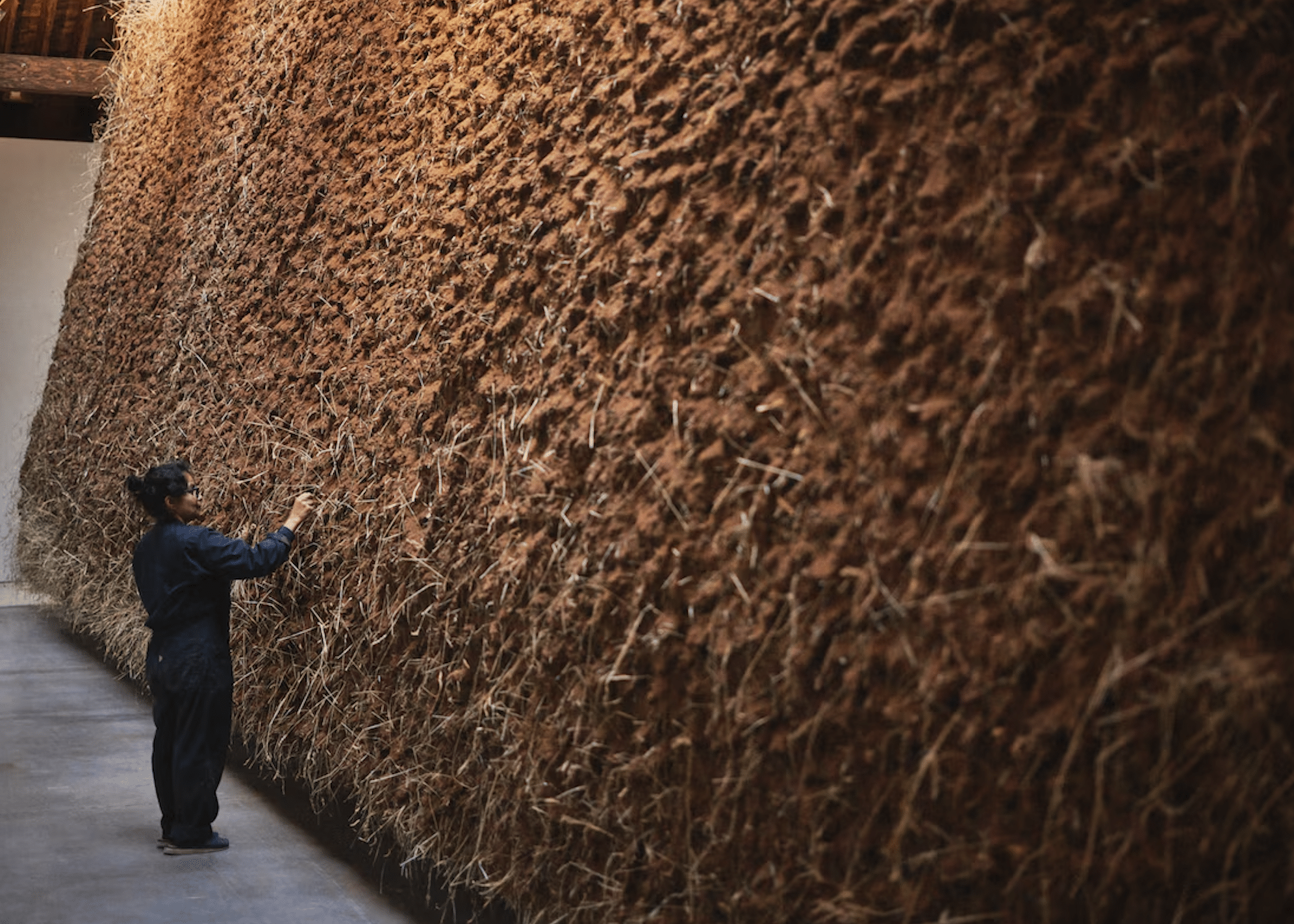 Artist Delcy Morelos stands before her enormous art installation, El abrazo, at Dia Chelsea in New York.